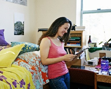 College website photo: Female in dorm