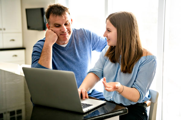 Student and parent checking a college website. Addressing their needs is a key part of college communication planning