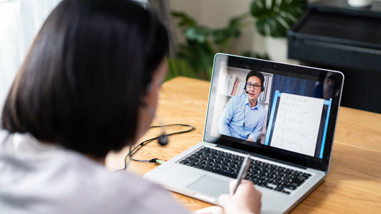 Instructional Design: Female student watching an instructor on her laptop