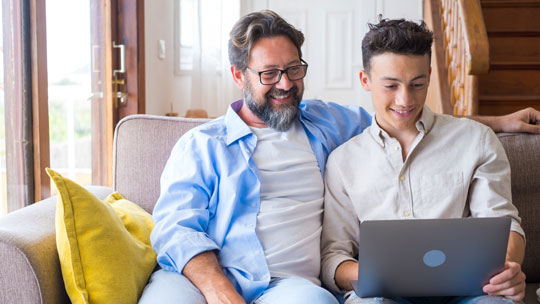 Blog: Engagement and College Student Search - father and teenage son looking at computer