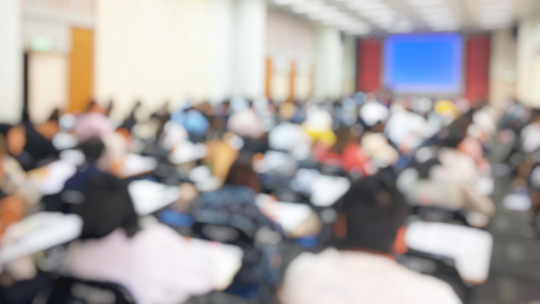 College Enrollment Deposit Blog: image of students at their desks in a college classroom 