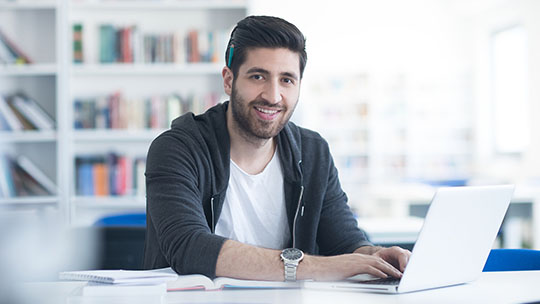 Blog: What Drives Grad Student Enrollment Decisions? 

Picture of a graduate student at a computer