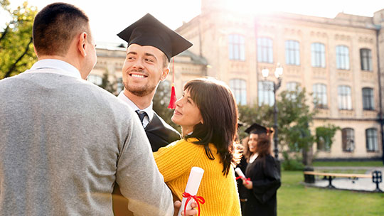 Blog on student satisfaction and family engagement: Graduating student with his parents