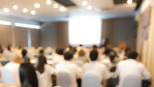 Blog: 3 Sessions to Explore at the 2024 RNL National Conference; picture of an audience at a conference presentation