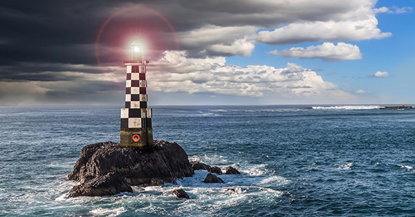 Blog on higher education navigating turbulent waters: Image of a lighthouse in rough seass