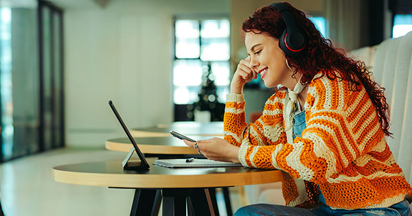 Blog on unlocking enrollment potential: Female high school student look at her phone