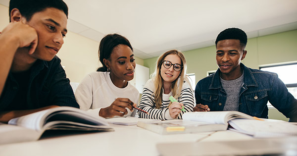Blog on 3 retention strategies: two male and two female students studying at a table.