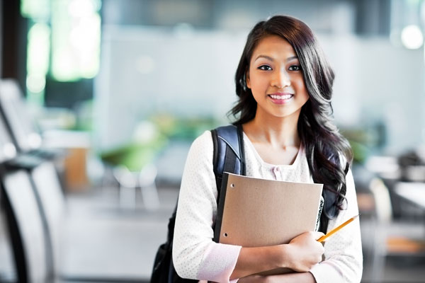 Student Satisfaction Inventory: Female college student carrying a notebook