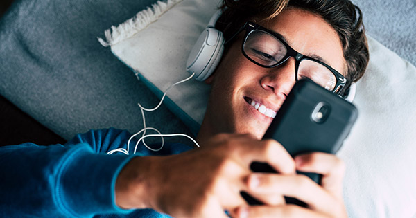 Blog on Personalized Video: Male student looking at a video on his phone