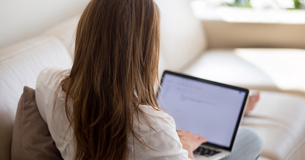 Priorities Survey for Online Learners: Female student looking at a laptop screen